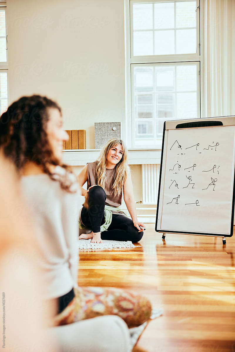 Smiling yoga teacher talking with her group