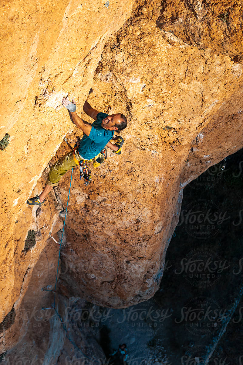 Mature climber climbing on crack