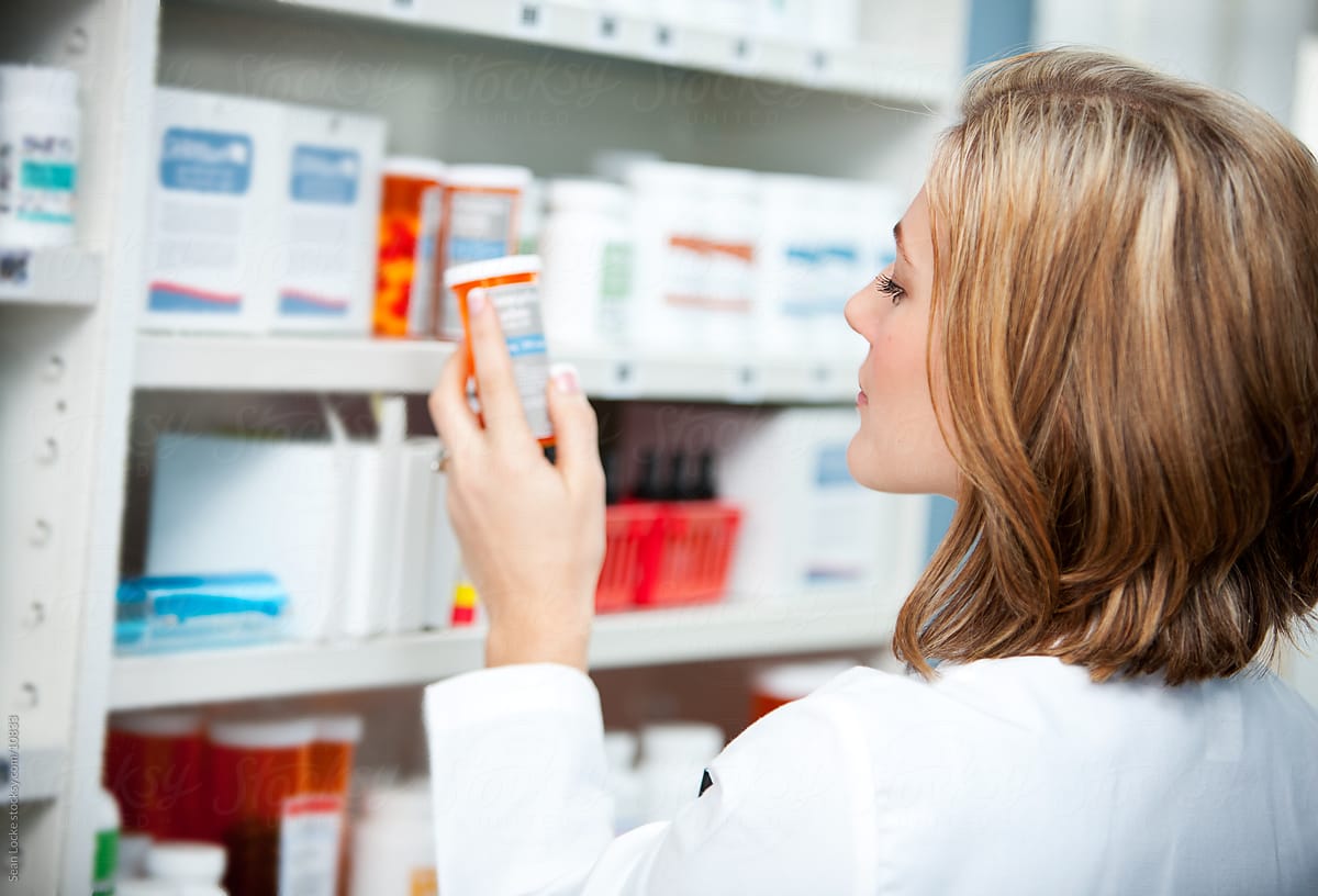 Pharmacy: Pharmacist Looking at Medicine Instructions