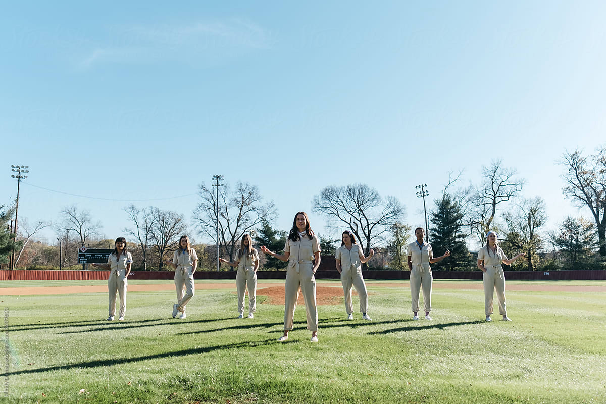 Young women stand in choreographed formation