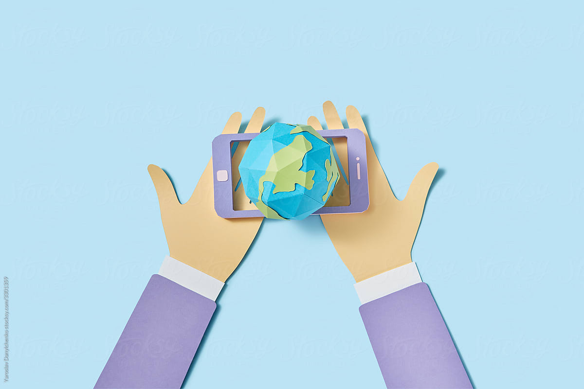 Papercraft world planet in the phone in the hands