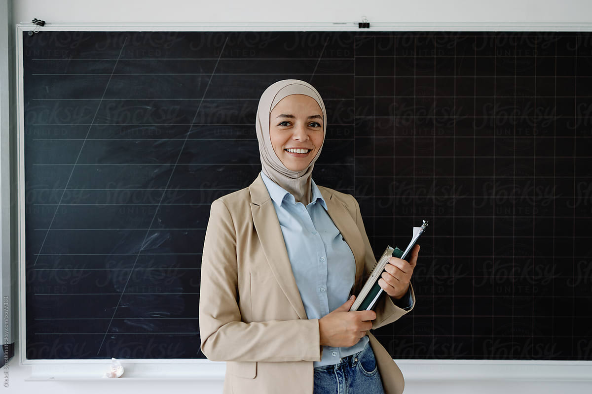Worker teacher posing blackboard multicultural folders