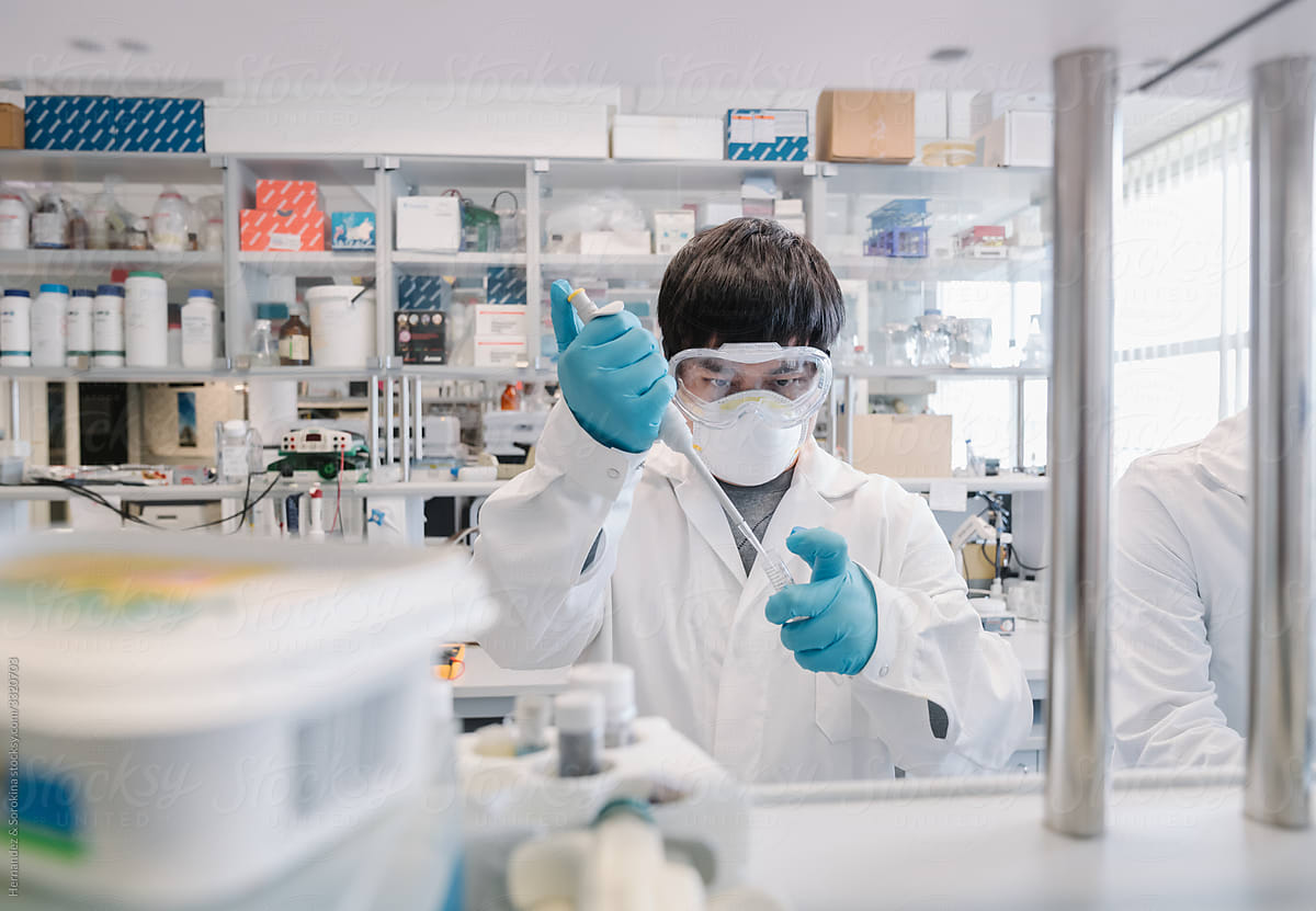 Scientist In Laboratory Using Pipette