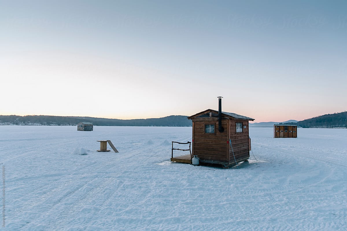 Ice Fishing Hut cluster on lake on Frozen Winter landscape Morning