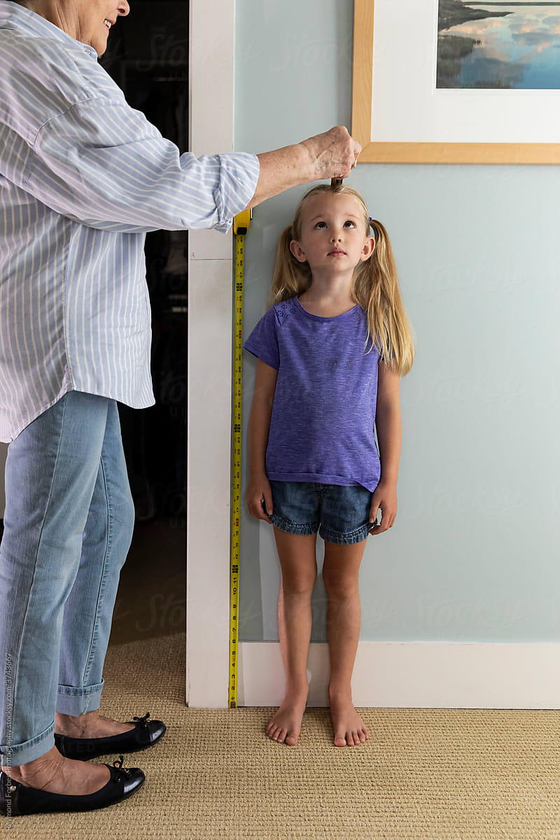 Young cute Girl Measuring her height