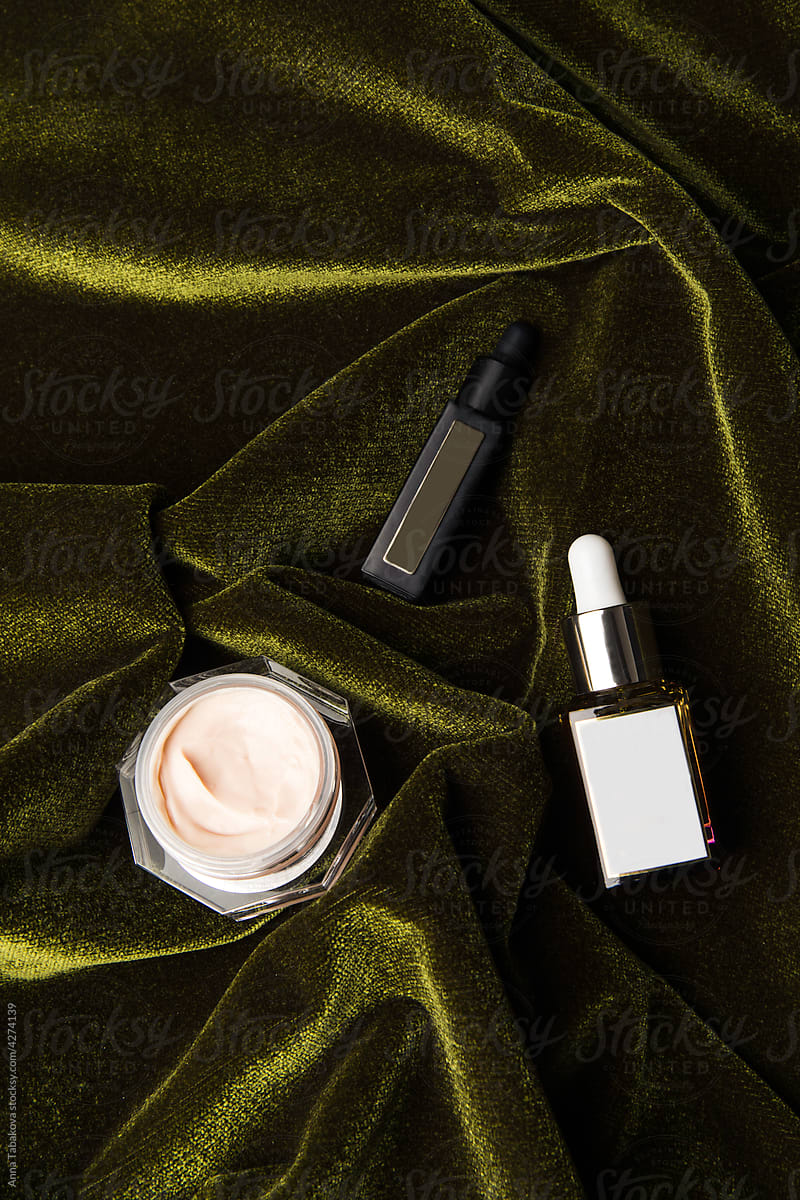 Beauty products on top of green velvet