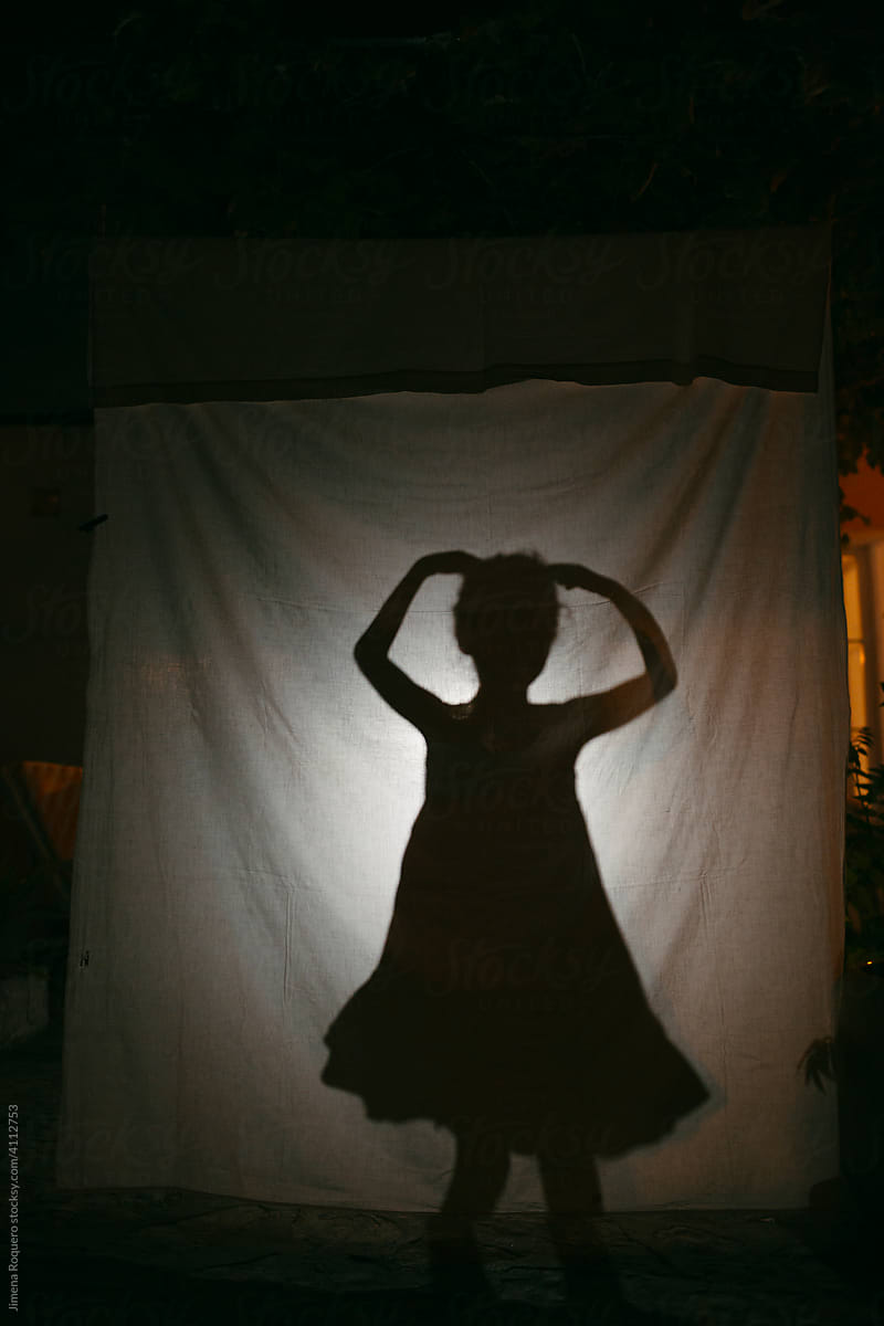 Kid doing Shadow play in country-house at night