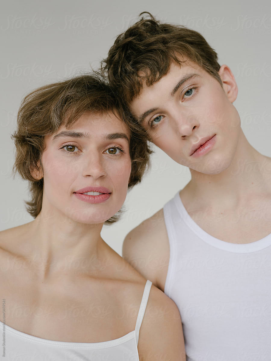 Young Woman And Androgynous Man Looking At Camera by Stocksy Contributor  Roman Shalenkin - Stocksy