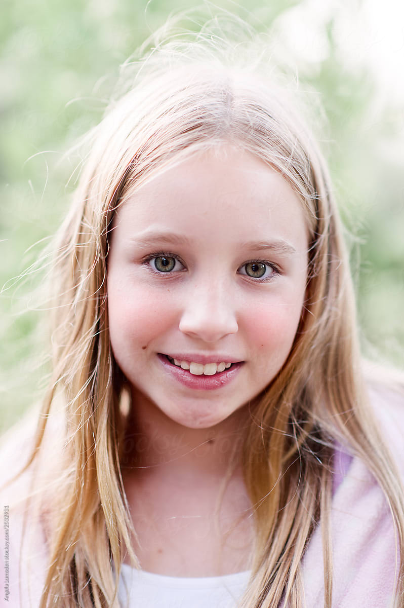 Smiling Portrait Of A Preteen Girl On A Summer Evening By