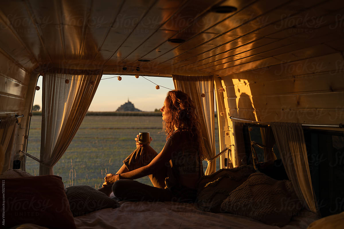 woman with coffe in camper van