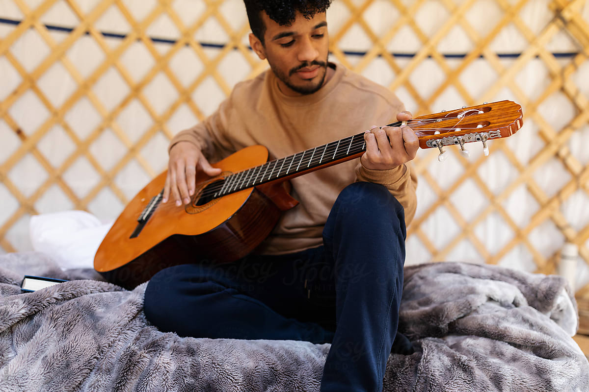 young man playing  guitar