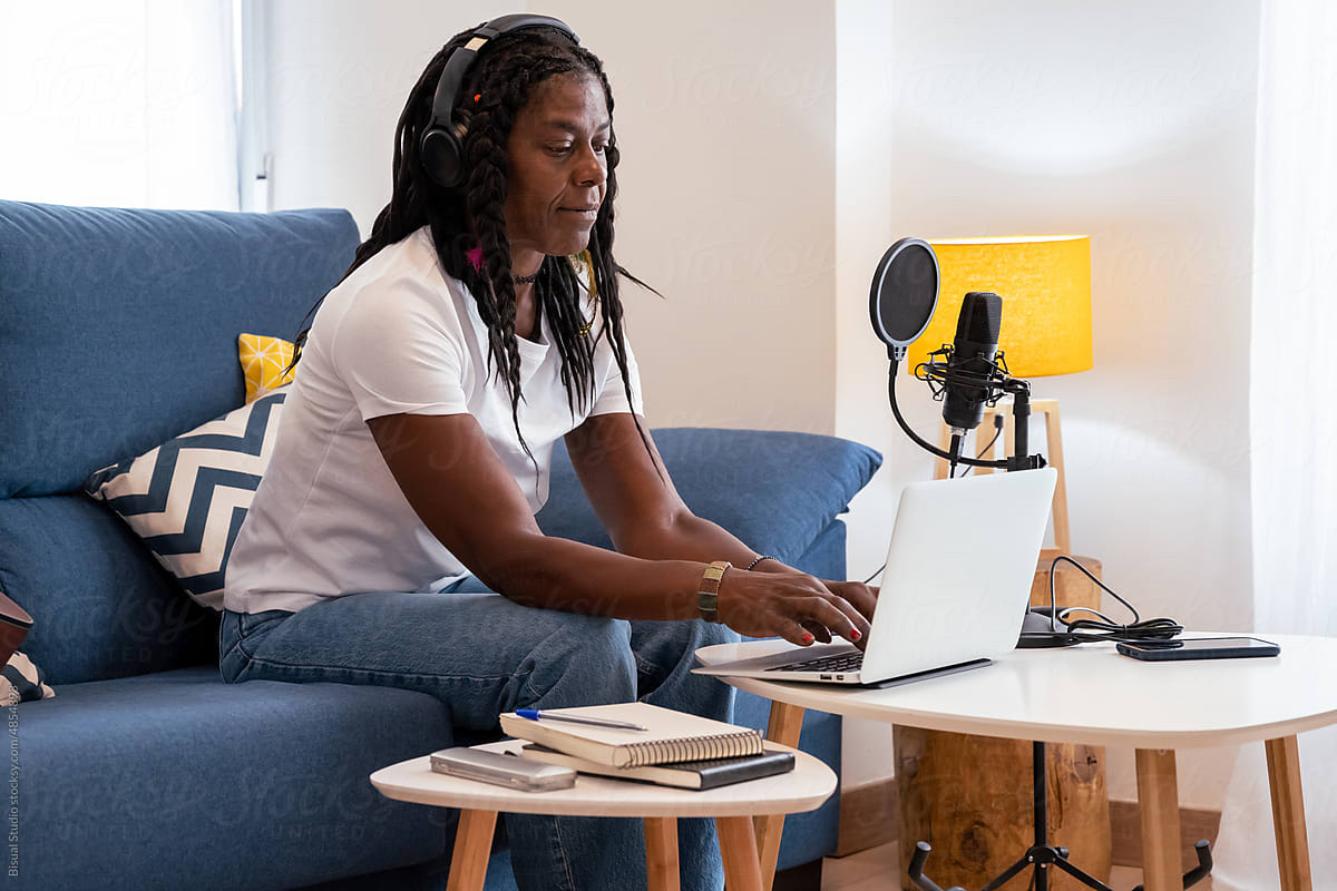 Black woman recording some music at home
