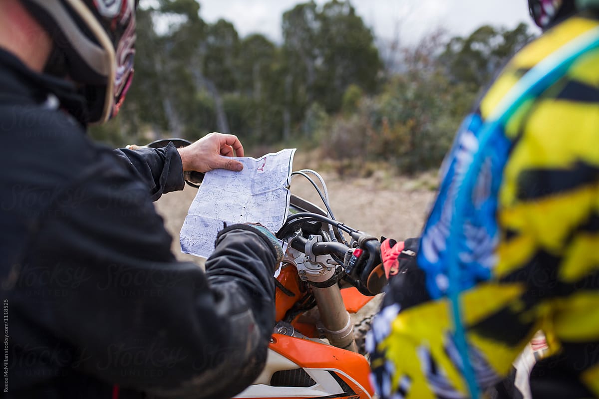 Two dirt bike riders checking a map