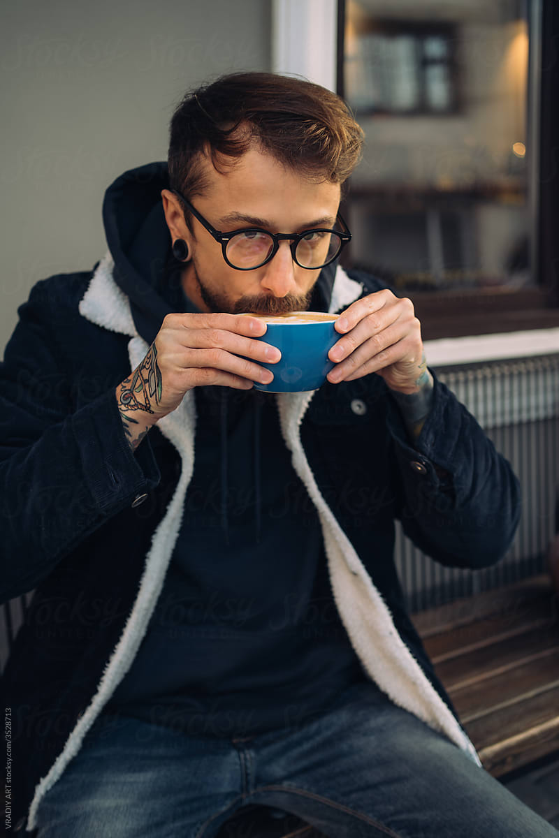 Man drinking coffee outside