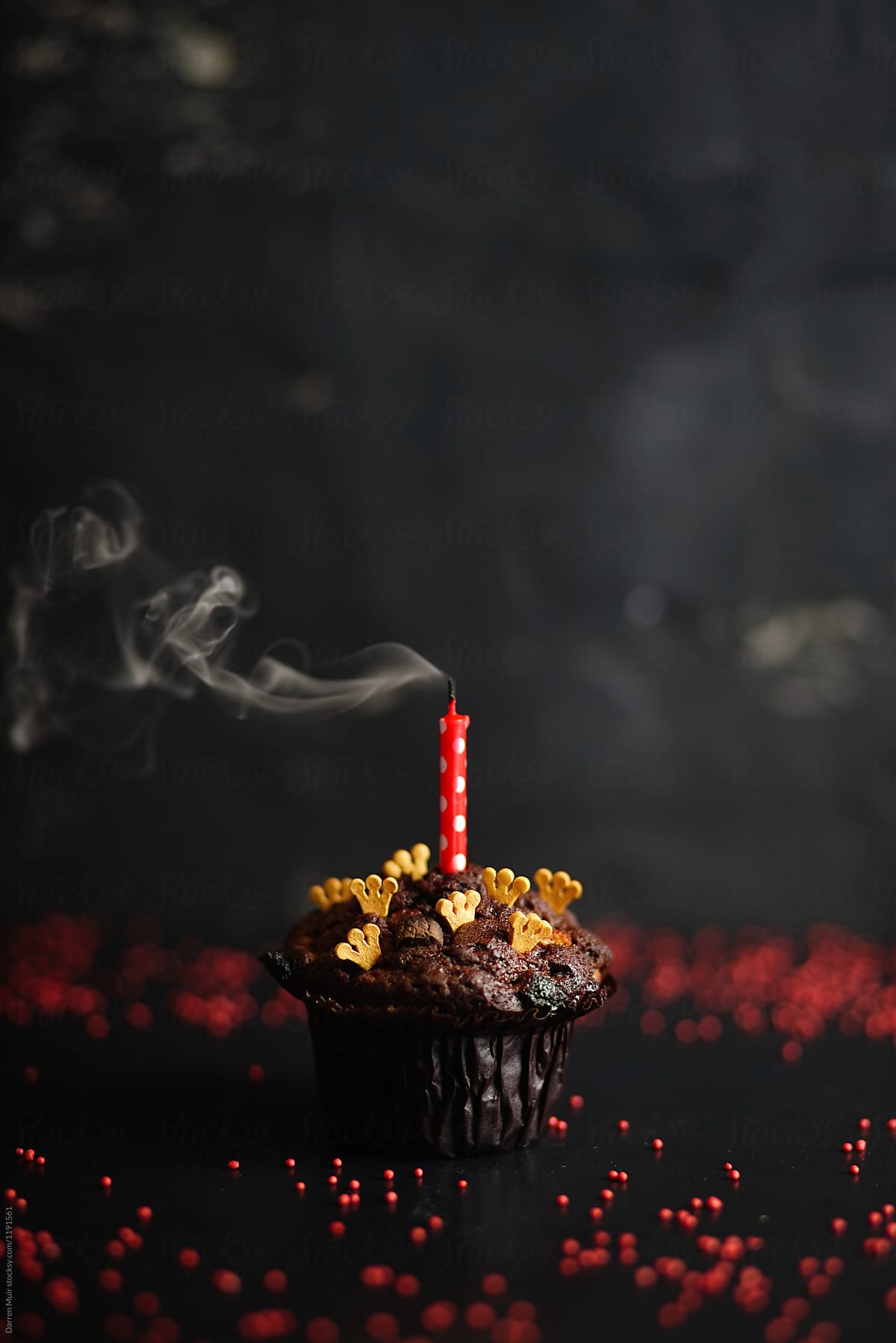 Chocolate cake with a single blown out candle.