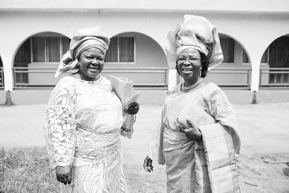 Two African women in beautiful traditional dress ready to attend a wedding.