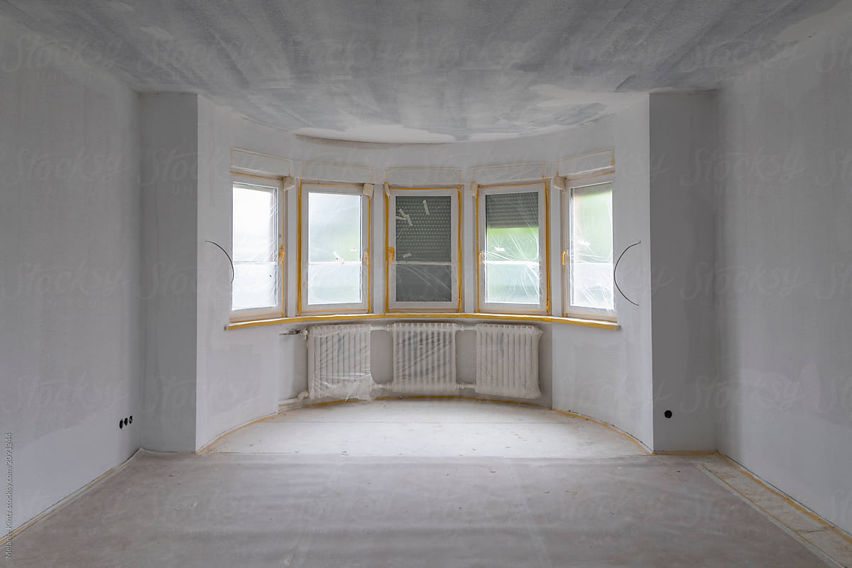 Spacious room with freshly primed walls and ceiling