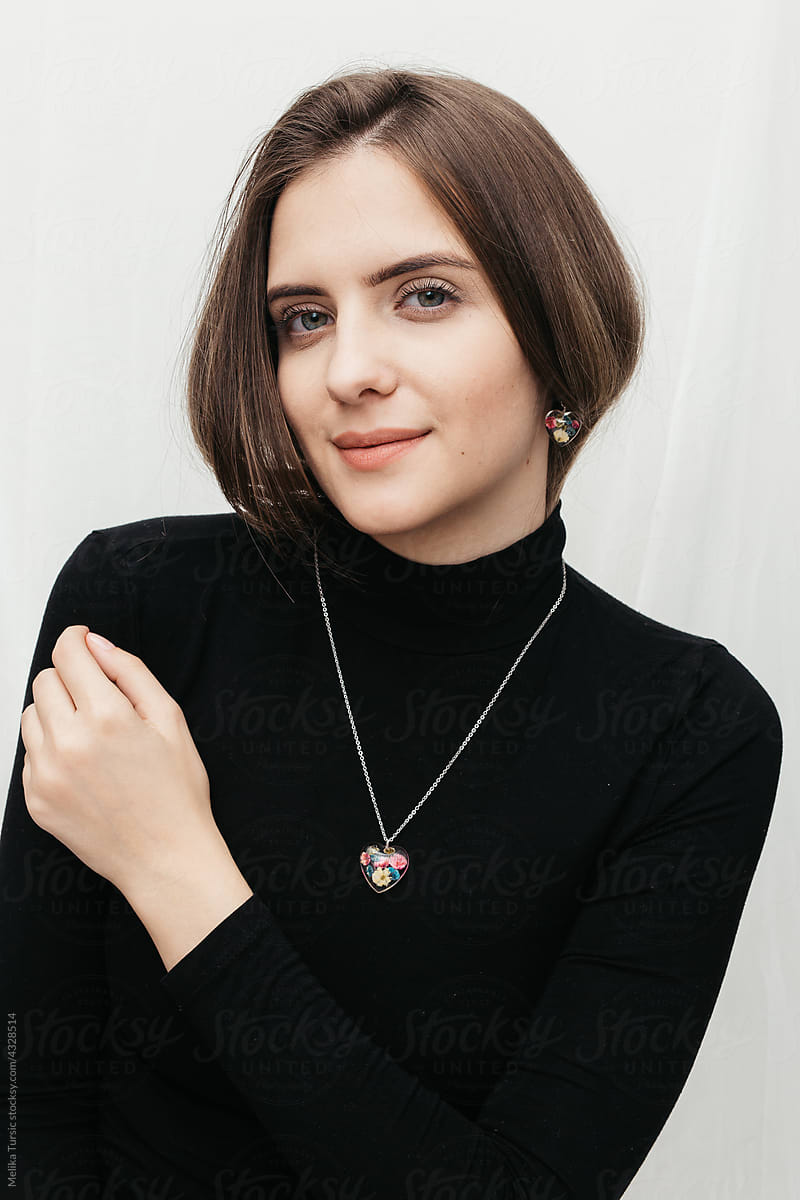 woman wearing floral epoxy necklace and earrings