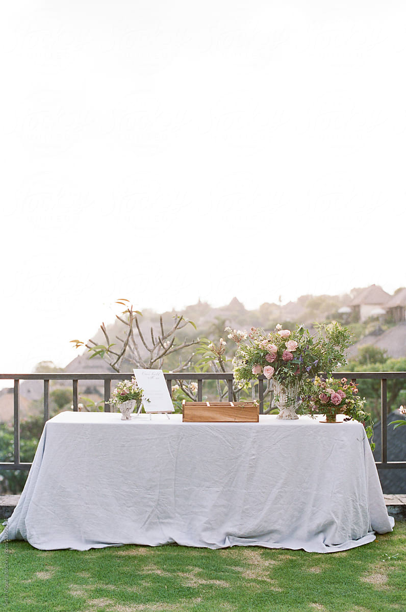 Table welcoming guests decorated with green & pink florals