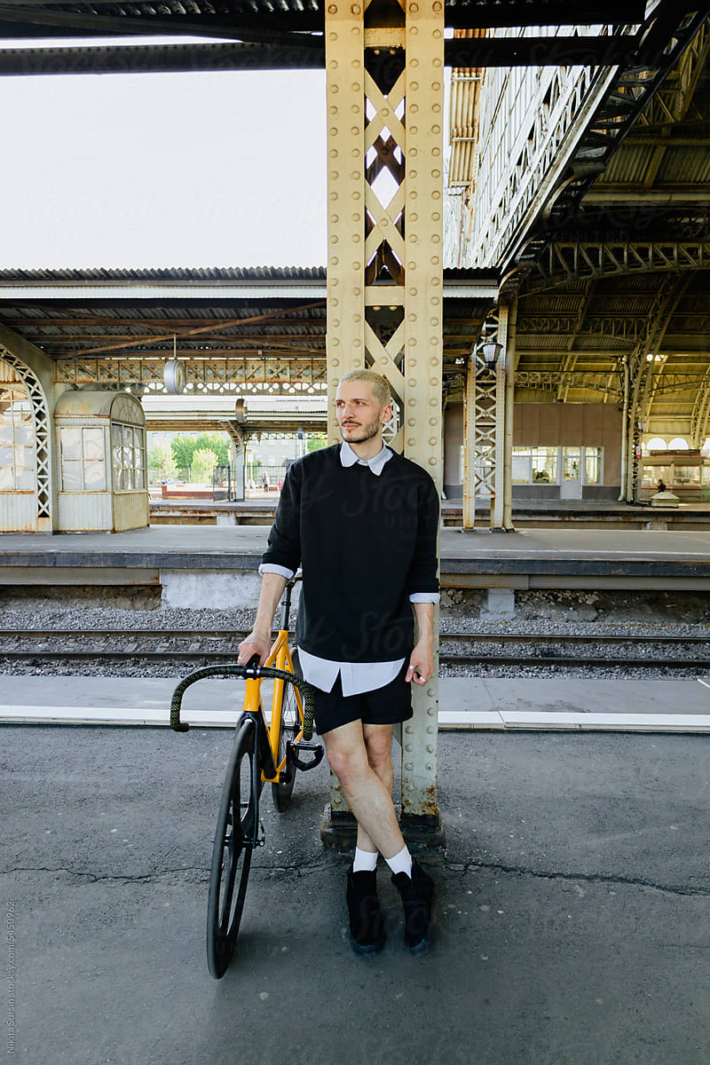 Man With Bicycle At Train Station