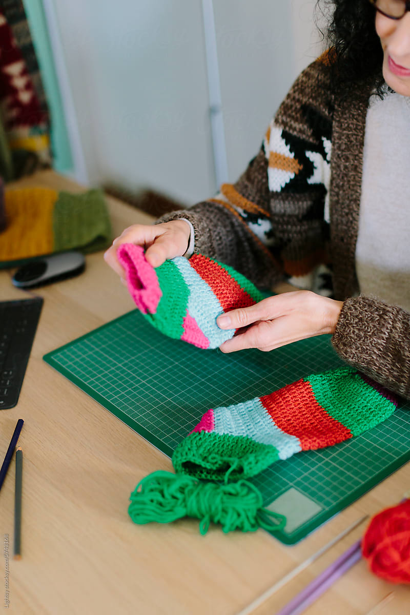 Woman looking at a handmade crochet sock
