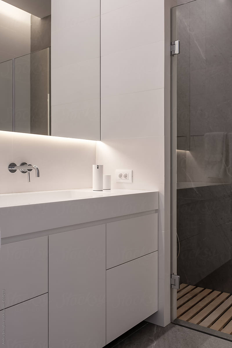 Interior of modern bathroom with tiled walls