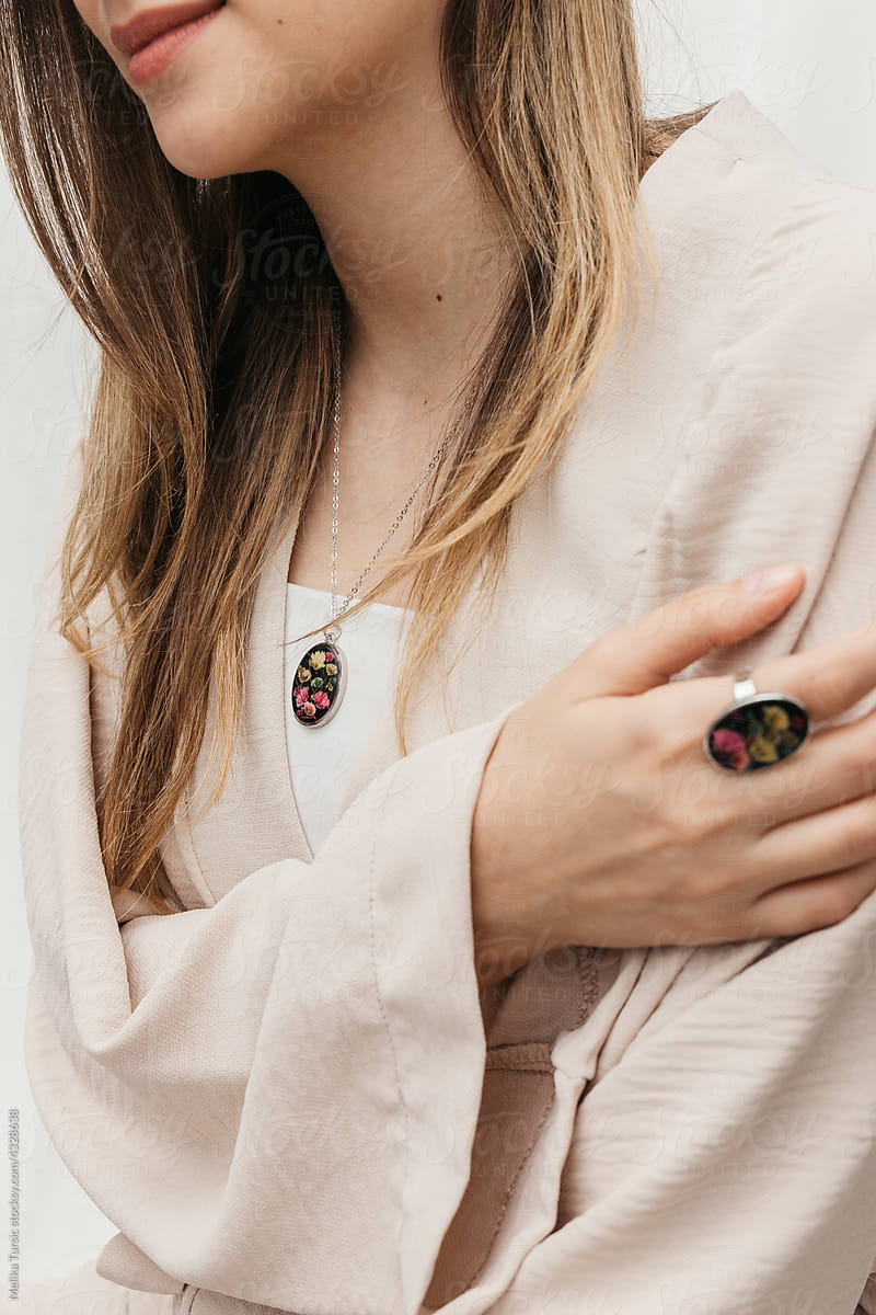 woman wearing floral epoxy necklace and ring