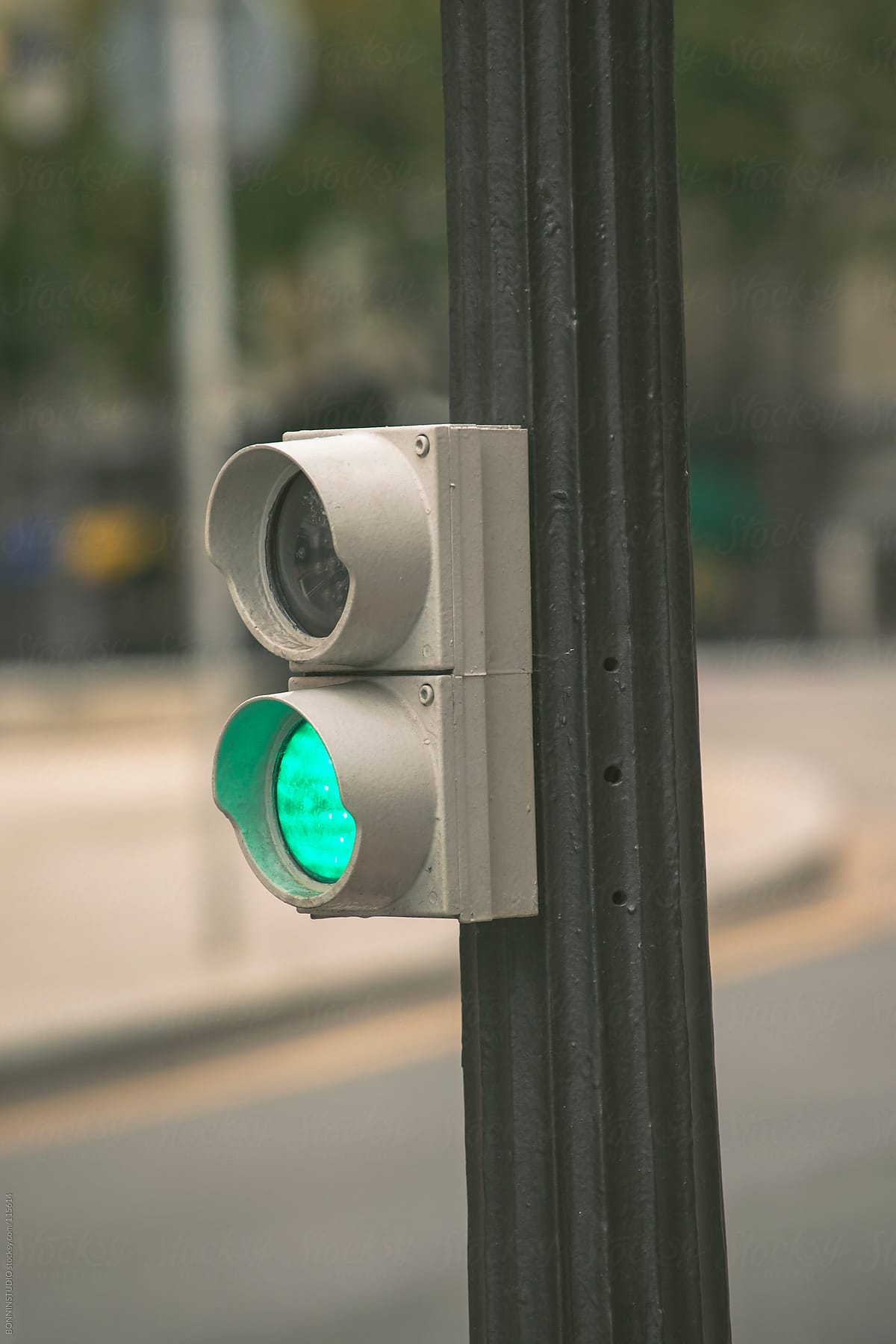 Green traffic lights on street.