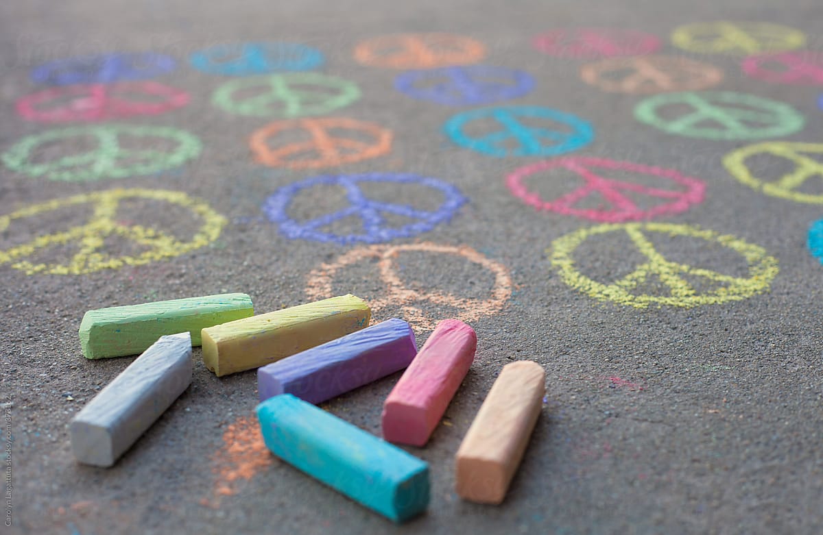 Many little peace signs drawn in colored chalk