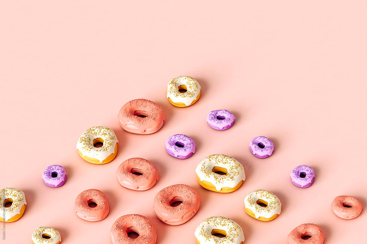 Organized colorful donuts on pink background