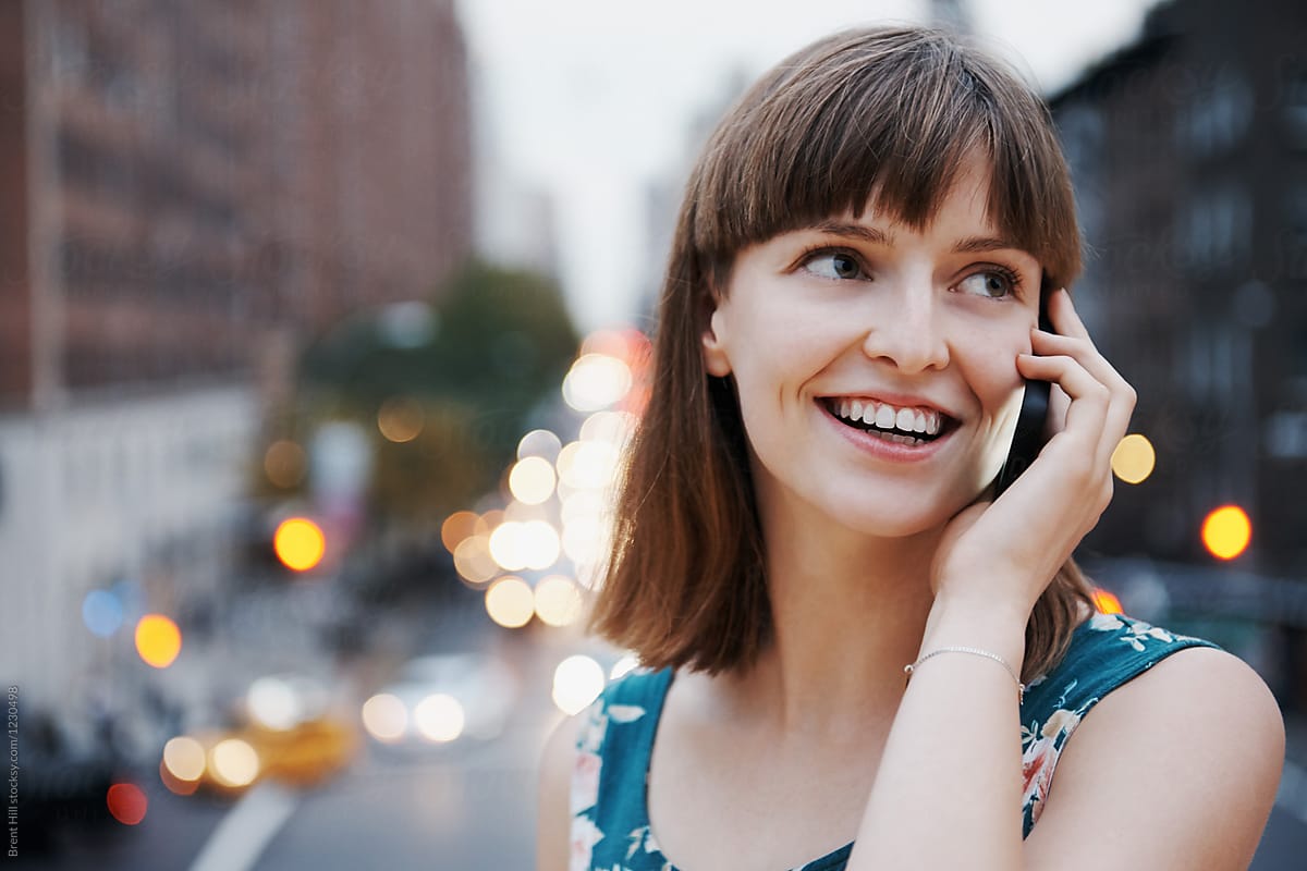 Young attractive woman talking on the phone whilst commuting to work