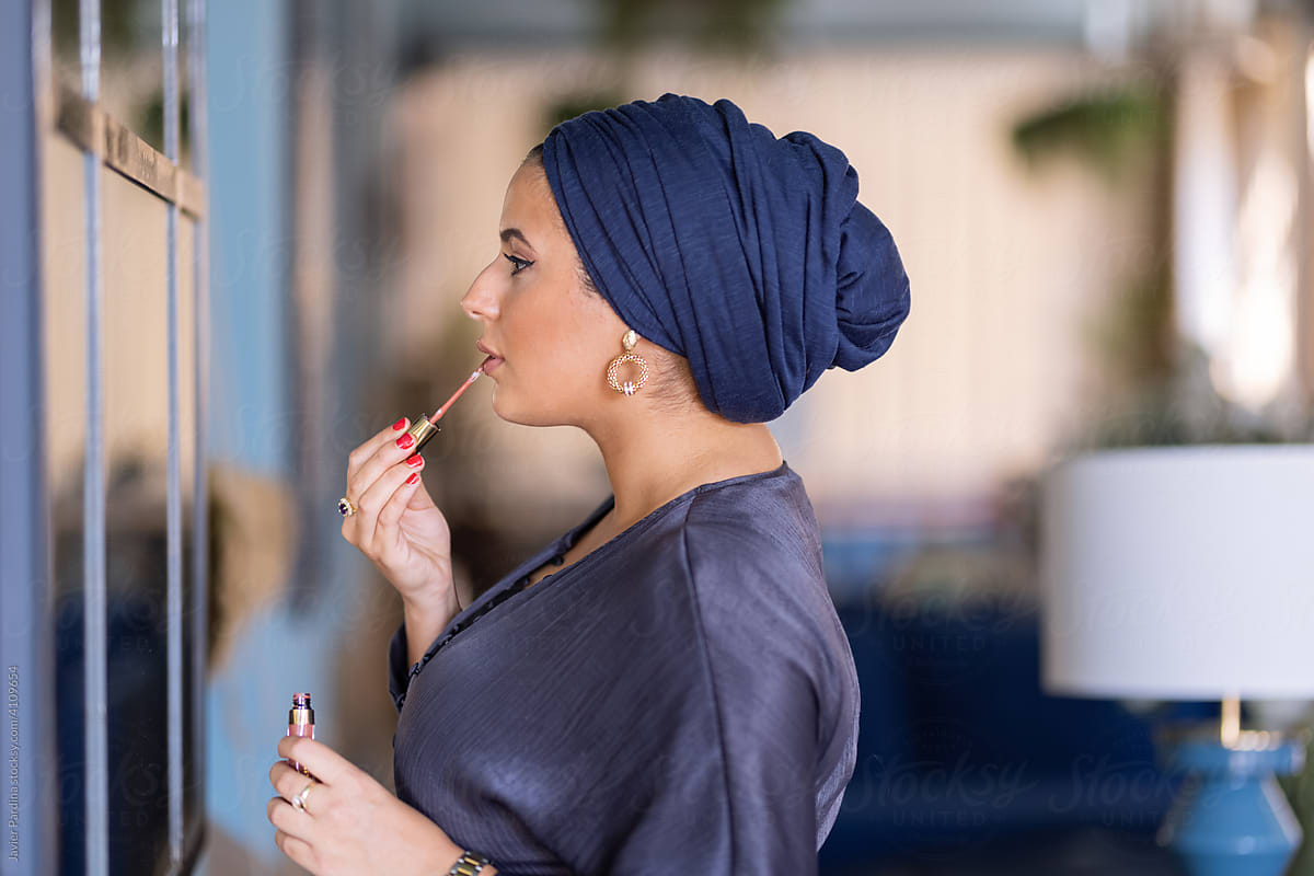 Modern islamic woman applying make up