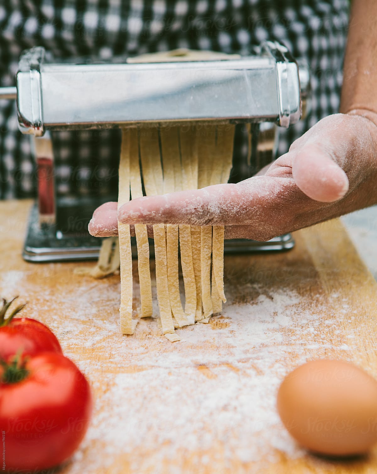 Man making fresh pasta with organic ingredients.