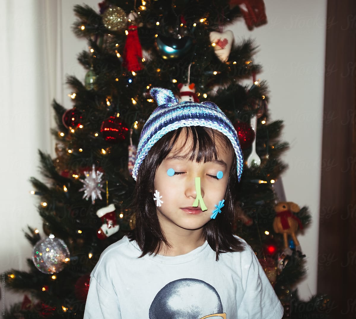 Young boy being silly with holiday stickers