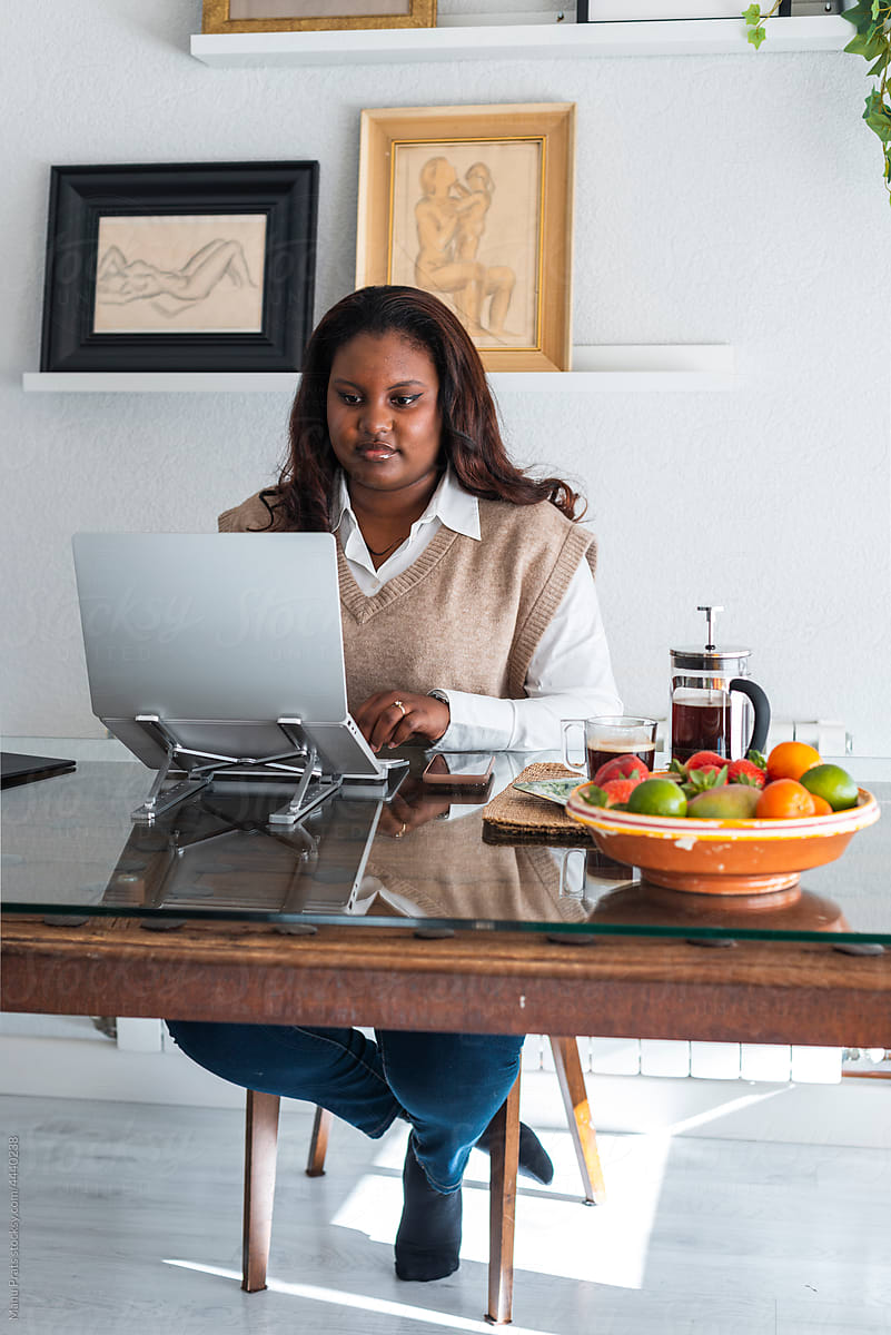 Curvy businesswoman teleworking at home office
