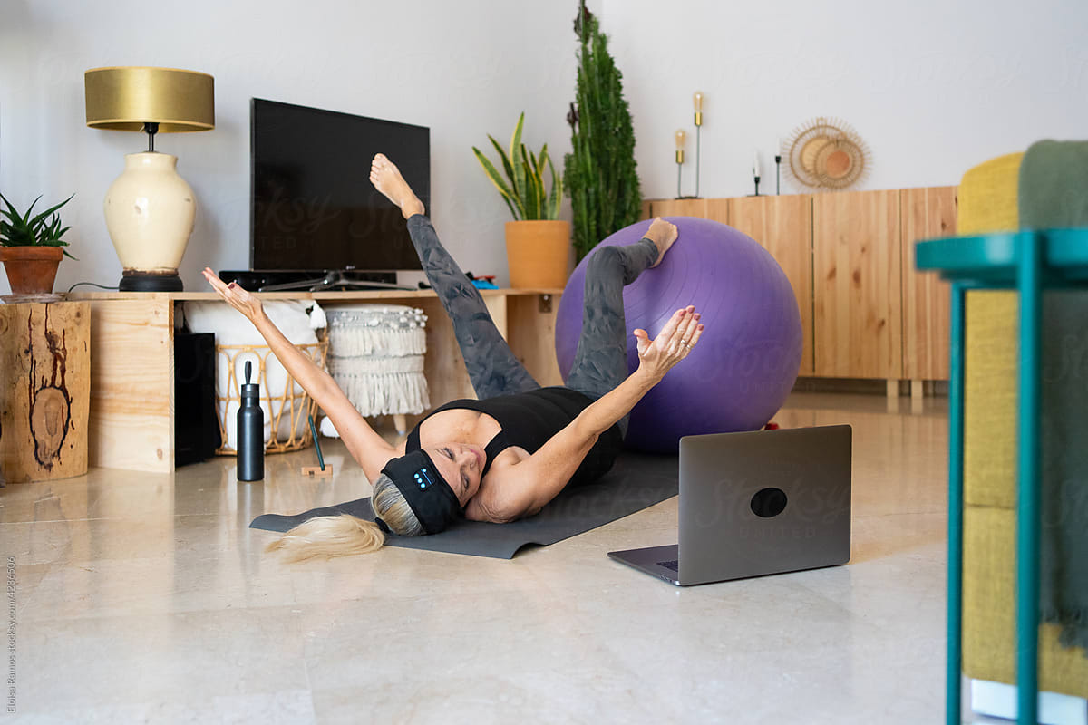 Energectic woman doing pilates at home