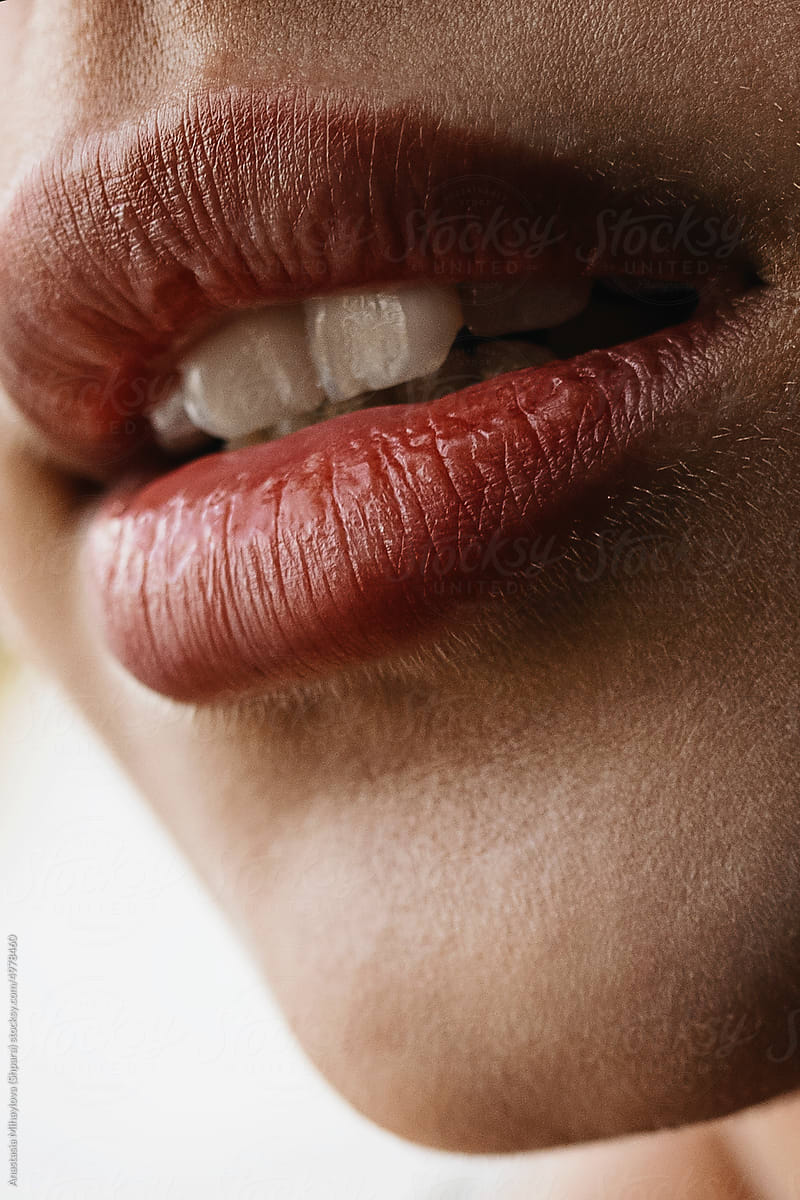 Close-up sensual woman\'s big plump red lips of anonymous woman
