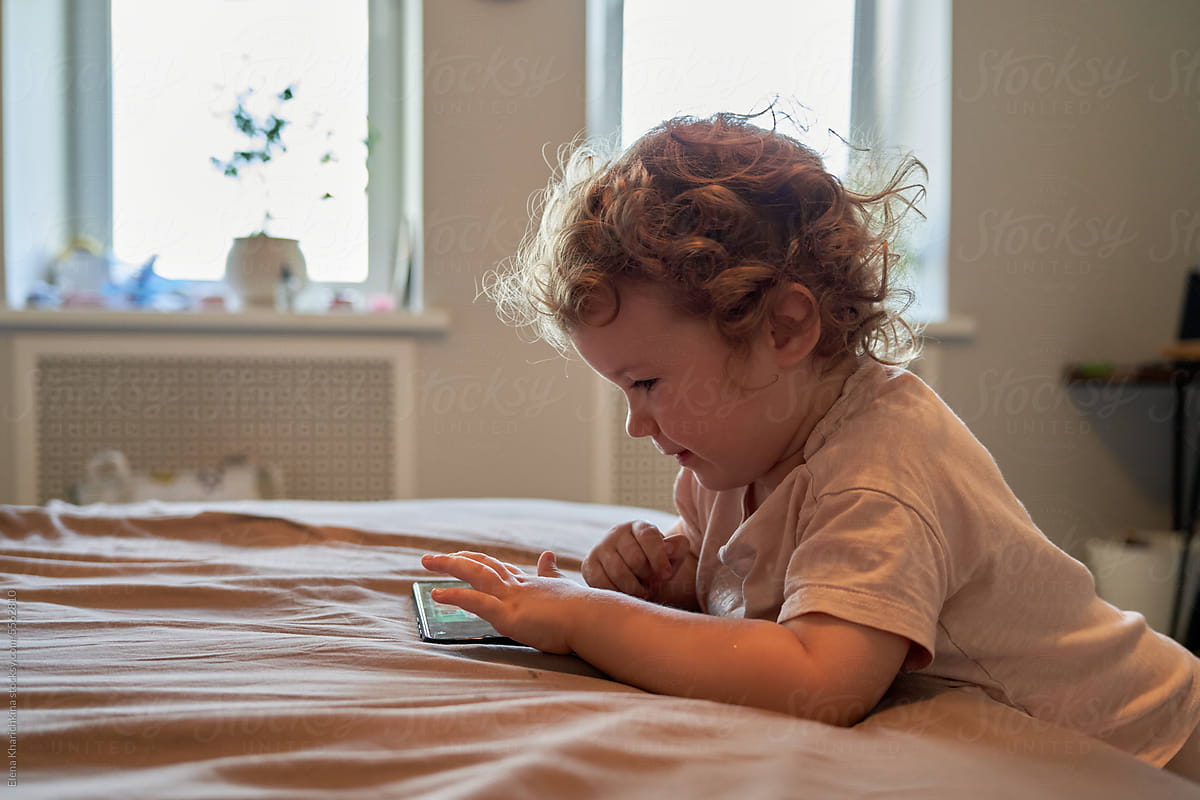 Cute Toddler Using Smartphone At Home