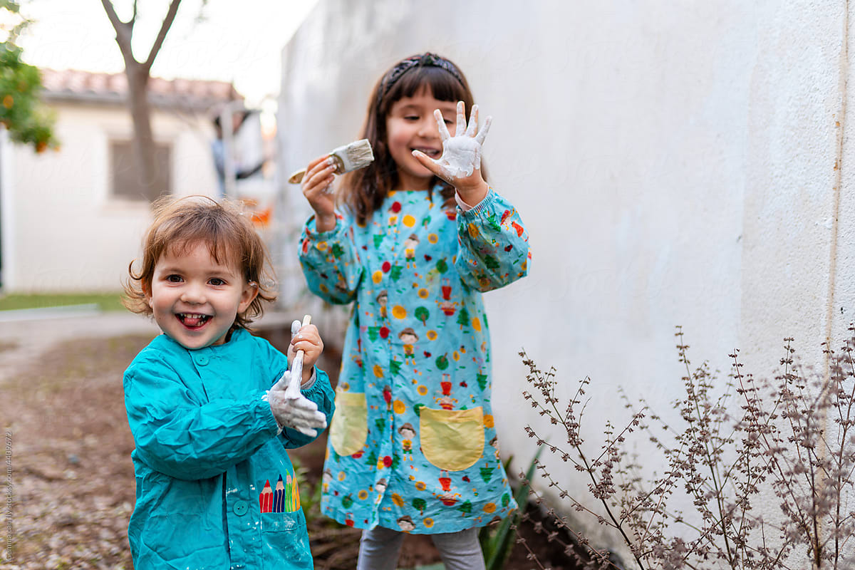 UGC - Happy sisters painting backyard