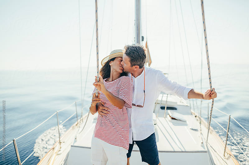 Kissing lovely couple on sailboat.