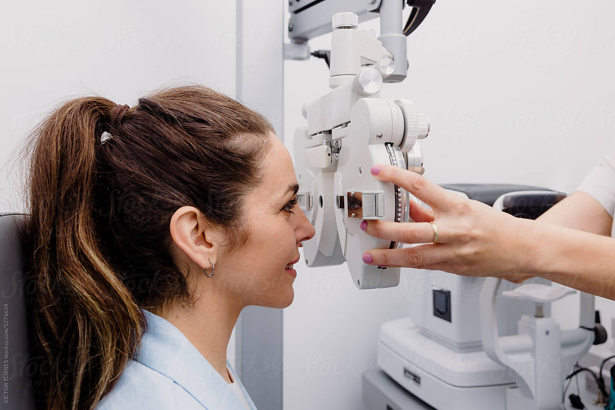 Oculist testing vision of young woman