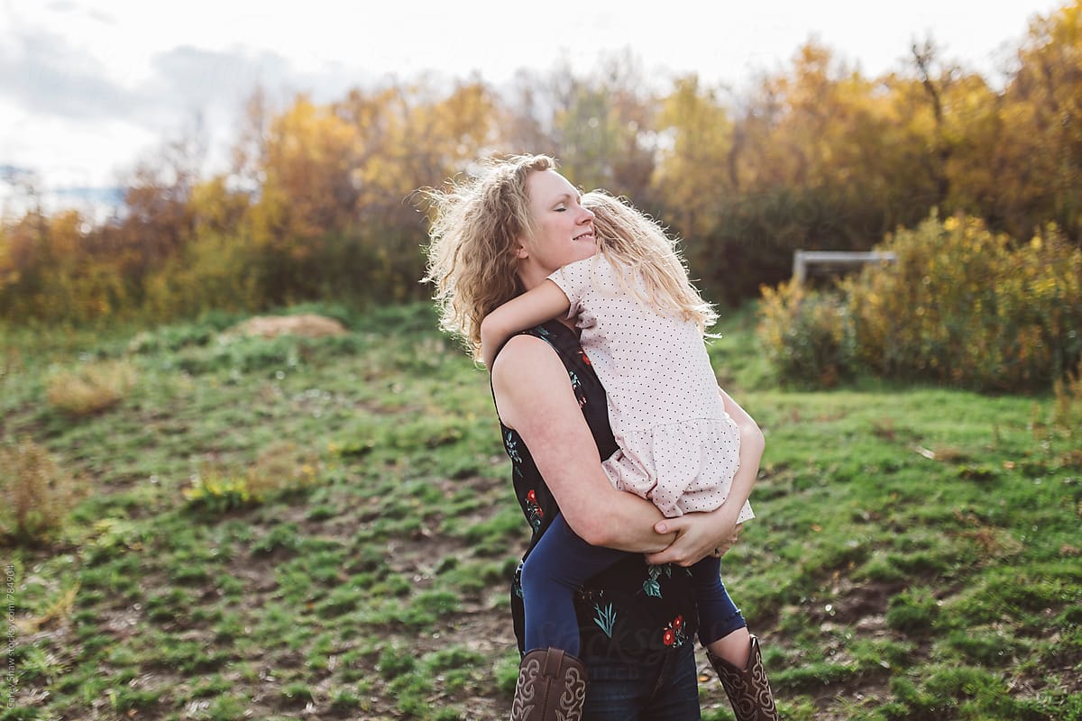 Loving Mother Carrying Daughter By Stocksy Contributor Carey Shaw Stocksy