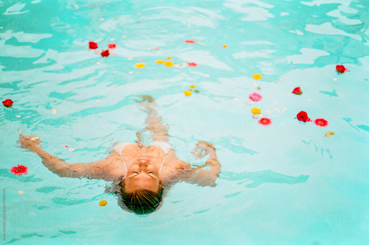 Woman floating with flowers