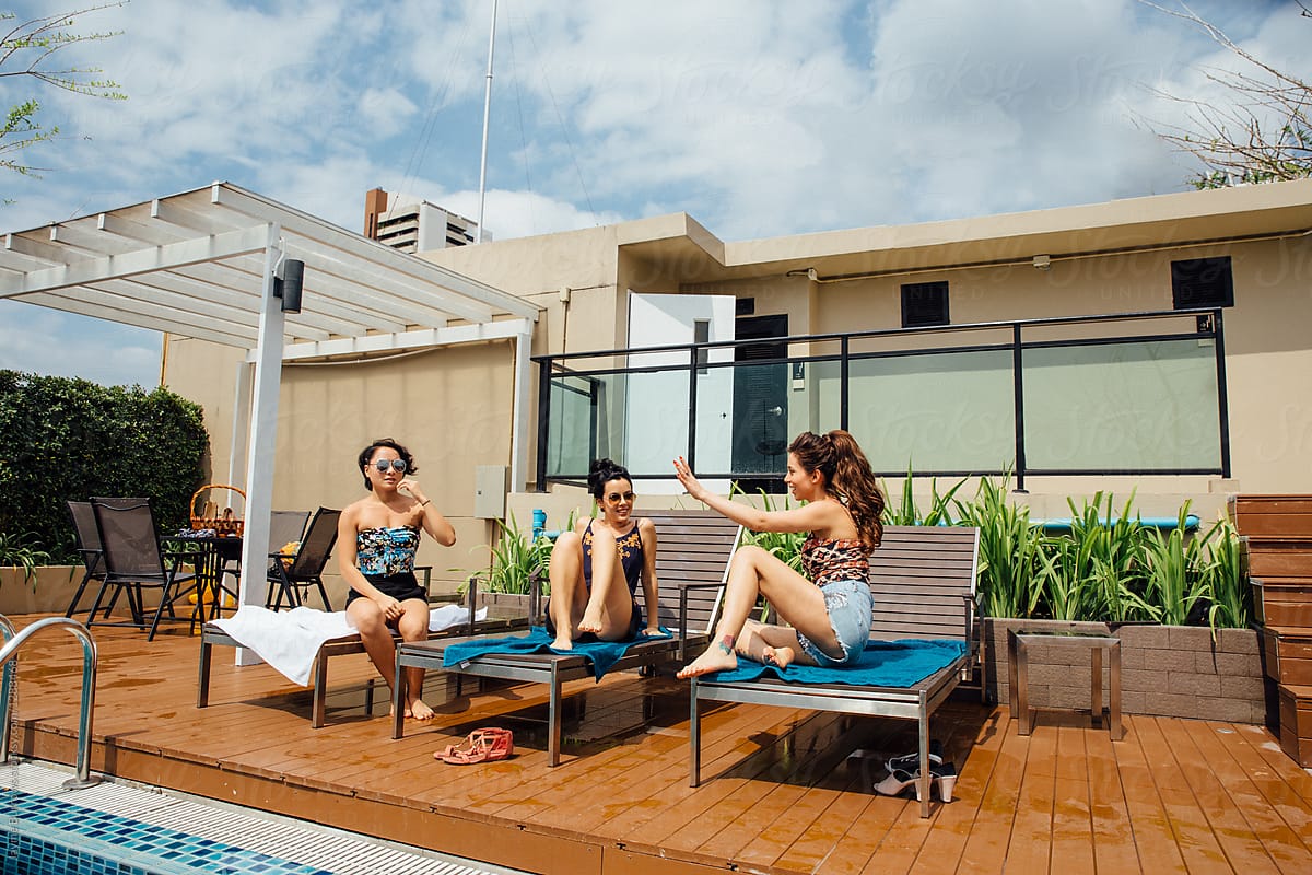 Three Women Sitting And Talking By The Pool By Stocksy Contributor Jayme Burrows Stocksy 