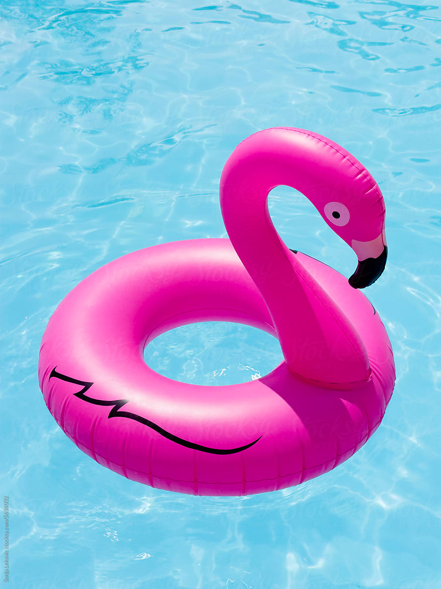 Inflatable pink flamingo toy in the swimming pool