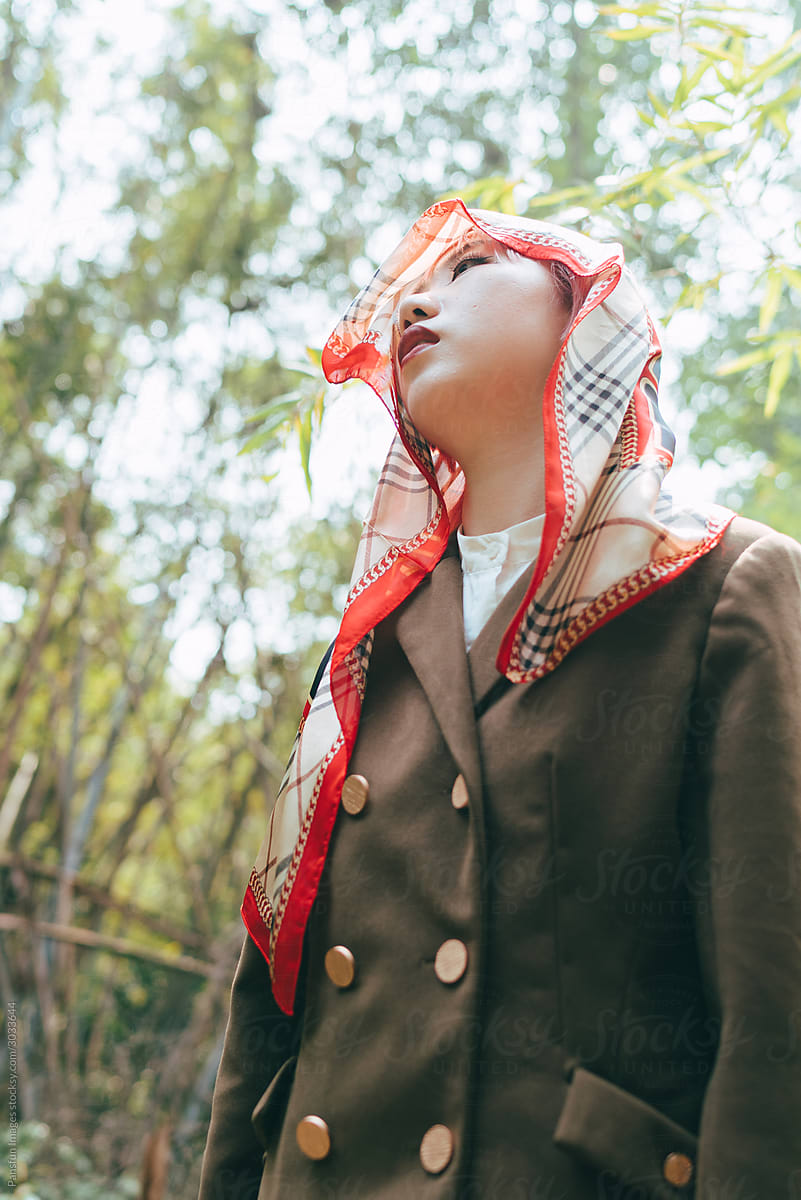 Stylish portrait of Asian young fashion woman put silk scarf on head