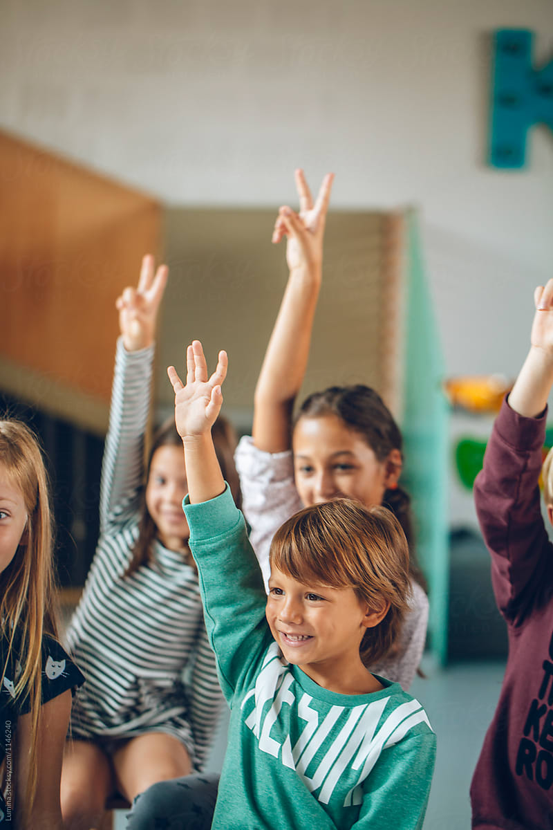 Primary School Students Raising Hands