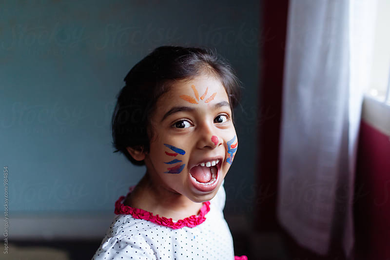 Little girl with a face paint having fun