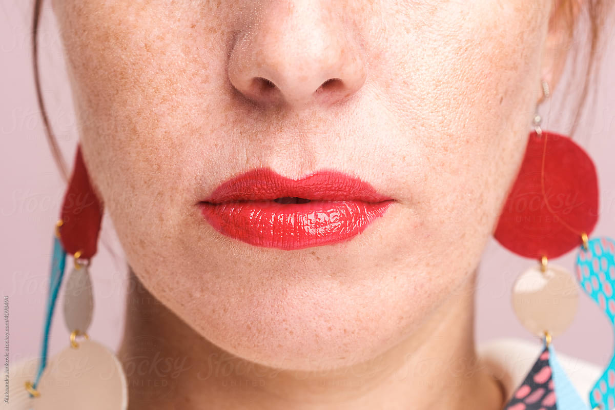 Close Up Of Woman With Freckles Wearing Red Lipstick