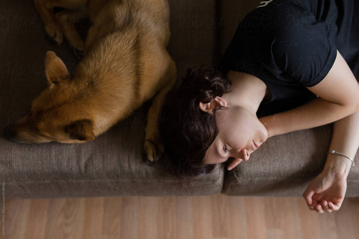 girl with dog sleeping on the couch